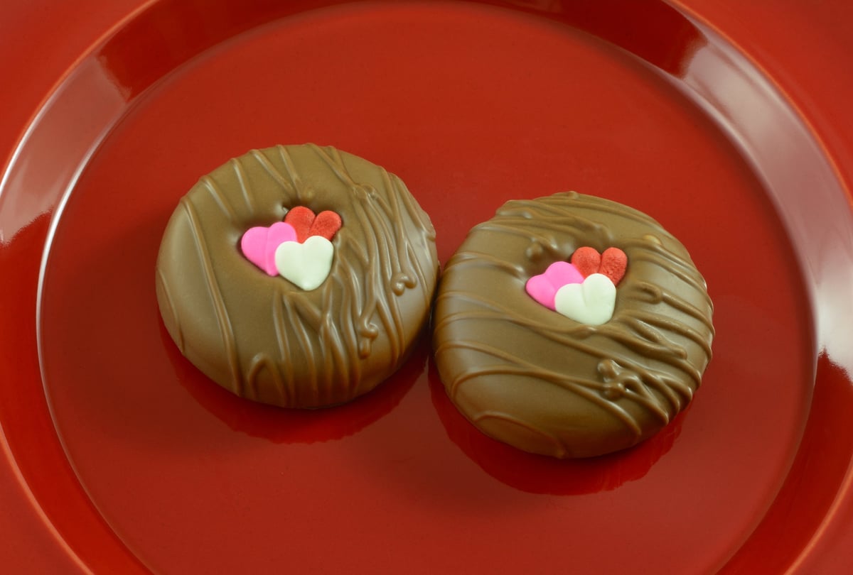Chocolate dipped sandwich cookies with heart decorations